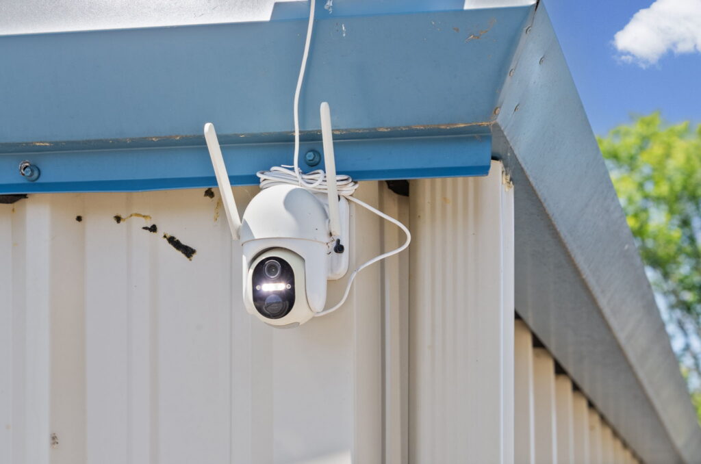 Military storage facility security camera mounted on exterior building
